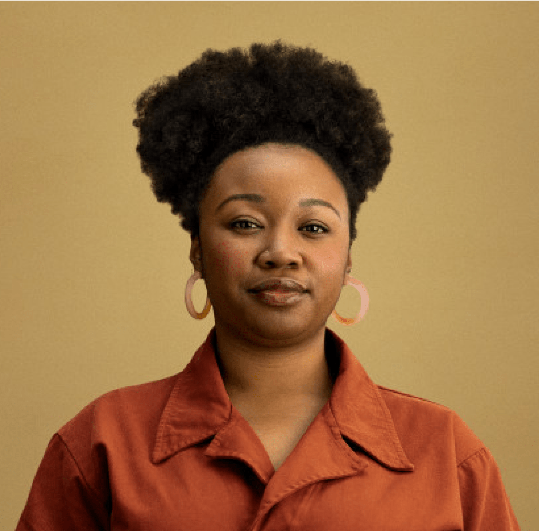 A woman with a poised expression against a plain background